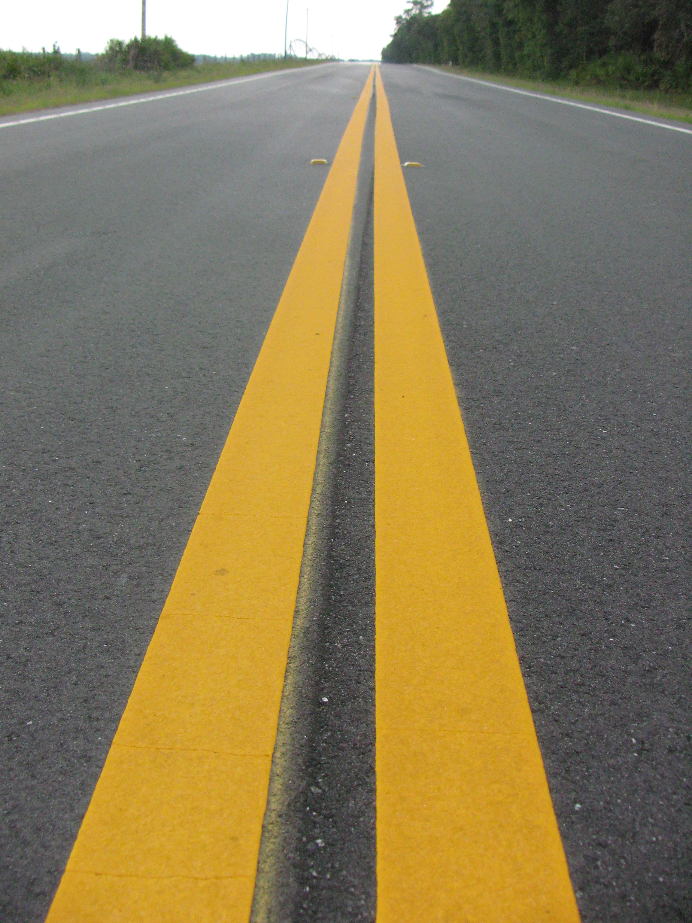 Photo of yellow stripes in road.